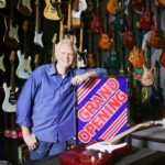 small business owner with grand opening banner