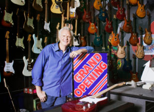 small business owner with grand opening banner